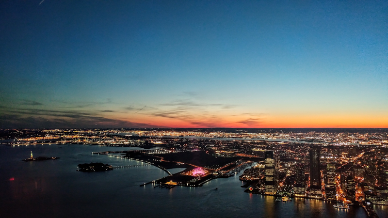 Sunset over New York Harbor on the 102nd floor of One World Observatory.