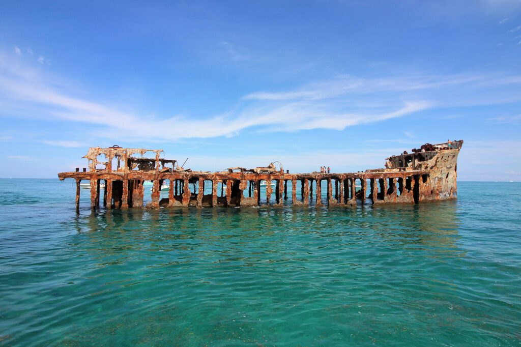 Take a swim into a reef in the guts of a century-old shipwreck in the Bermuda Triangle – and then jump off it – if you dare.